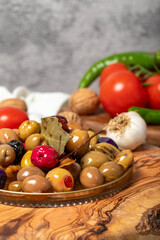 Mixed olives. Special mixed olives prepared with various olives on a wooden serving board. Close up