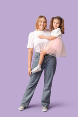 Portrait of young mother and her daughter on lilac background. Mother's Day