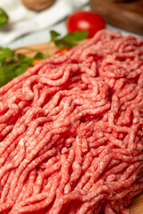 Ground beef. Raw ground beef or minced meat on wood serving board