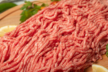 Ground beef. Raw ground beef or minced meat on wood serving board. Close up
