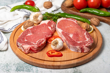 Beef entrecote. Raw beef ribeye on wood serving board. Close up