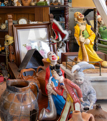colorful clowns displayed in an antique store