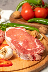 Beef entrecote. Raw beef ribeye on wood serving board. Close up