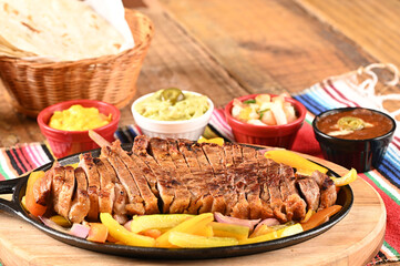 roast beef with seasonings and sliced ​​barbecue salad served on plate on wooden table