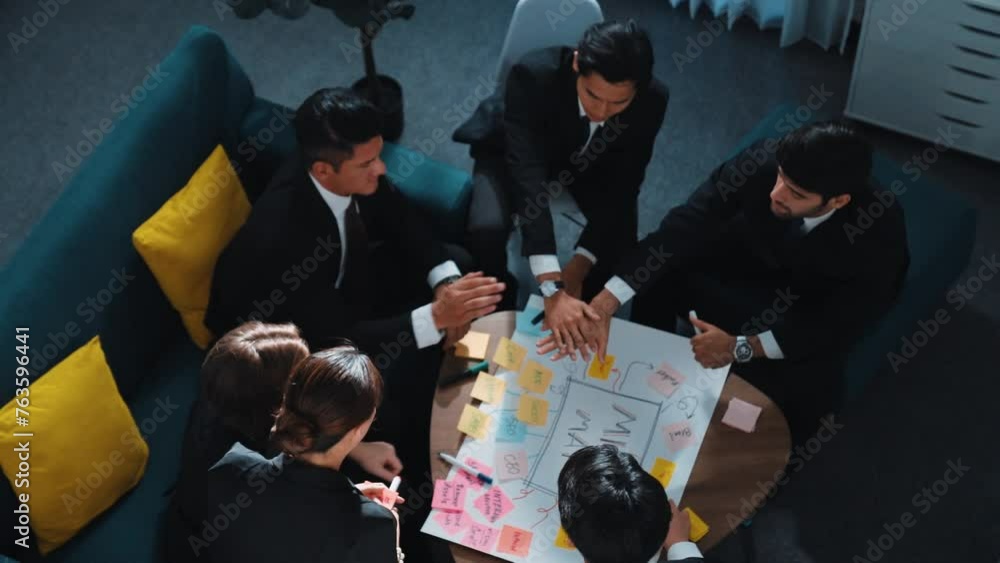 Poster top view of professional business team putting hands together and clapping hands to celebrate succes