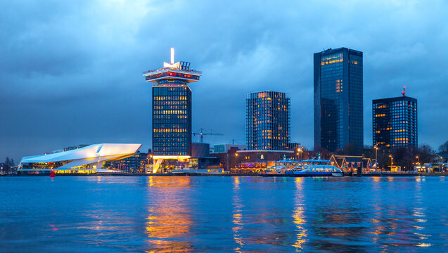 Amsterdam noord city skyline with reflection in the IJ river  at sunset, metropolitan, skyscraper, Eye Film Museum 