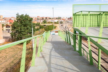 pedestrian walkway to cross the railway with a view of Astorga, province of Leon, Castile and Leon,...