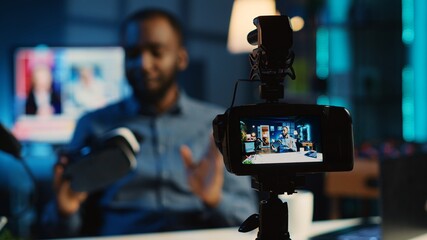 Tech content creator filming technology review of newly released gaming VR glasses for audience. African american influencer showing virtual reality goggles to subscribers