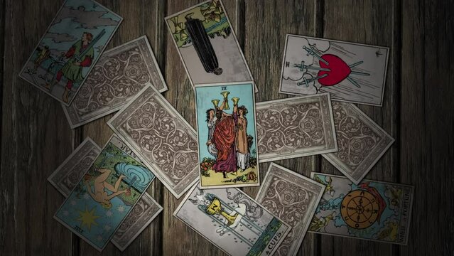 Vilnius, Lithuania - October 13, 2020: Tarot Cards Used In Occultism Falling. Three Of Cups Depicts Women Dancing In A Circle. Mystic Rite In Occultism. Divination In Occultism Reveals Future.