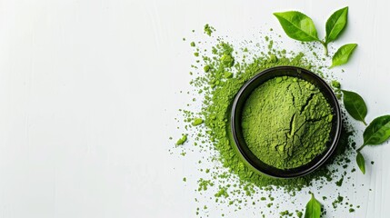 This image shows a bowl of organic matcha green tea powder with green tea leaves on a white background. The powder is a bright green color and has a smooth, fine texture. - obrazy, fototapety, plakaty