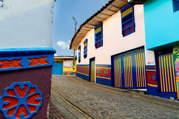 Cobblestone street with typical colorful houses in Guatape, Colombia