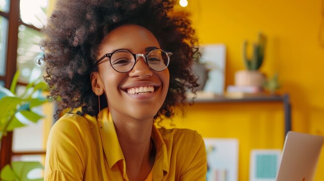 Image of young beautiful joyful woman smiling and looking aside while working in office