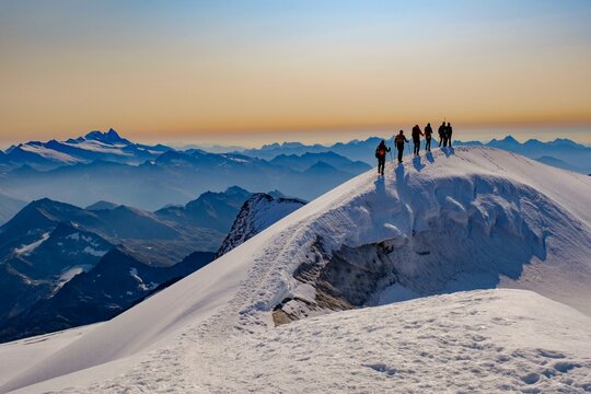 Mountaineer on the summit ridge of the Grossvenediger, behind the Grossglockner, Hohe Tauern National Park, Salzburger Land, Austria, Europe