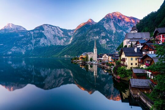 Local view of Hallstatt and the protestant church at sunrise, reflected in the lake Hallstatt, Salzkammergut, Dachstein region, Upper Austria, Austria, Europe