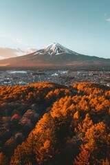 Mtfuji  tallest volcano in tokyo, japan with snow capped peak and autumn red trees landscape