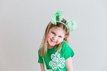 Little girl dressed up in green for Saint Patrick's Day holiday.