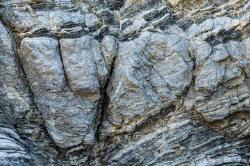 Nature force compressed cracked rock layers structure formation close-up details, in various...