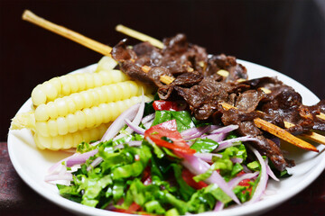 Typical peruvian food - grilled beef with corn and salad.