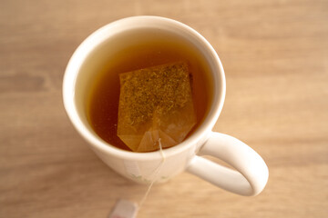 A mug of tea on a wooden table, sun, warm, cold. High quality photo