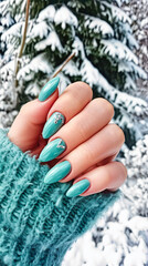 Elegant Womans Hand With Blue Manicure in Green Sweater