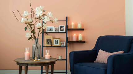 Serene nook, pastel peach wall, navy blue armchair, ladder shelf with scented candles, framed photos, and a vase of magnolias on a round end table. Gentle morning light.