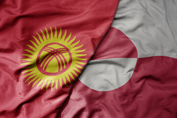 big waving national colorful flag of greenland and national flag of kyrgyzstan.