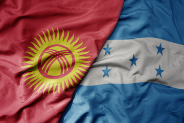 big waving national colorful flag of honduras and national flag of kyrgyzstan.