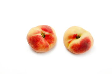 Two saturn peaches or flat peaches isolated on white background with clipping path..