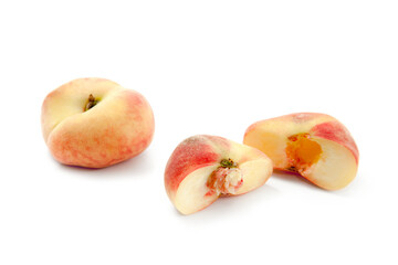 Whole and half of saturn peach or flat peaches isolated on white background with clipping path..