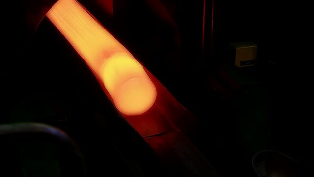 Orange Hot Yellow Copper Pipe on Production of Non-Ferrous Automated Line at modern industrial plan. Heavy industry. Conveyor line. Manufacturing Plant. Ferrous metallurgy. Wide Shot