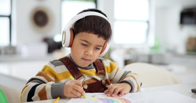 Child, crayons and coloring art in home with headphones for creativity with music playlist, education or homework. Boy, student and drawing picture in apartment with streaming audio, podcast or track