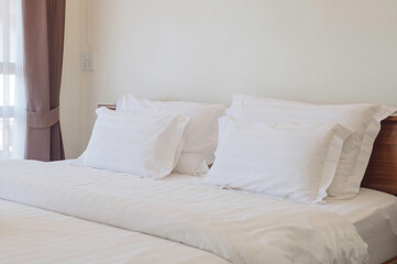 Fototapeta na wymiar White bed linen with pillows 