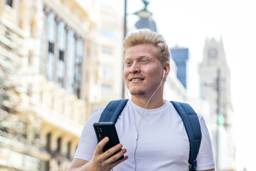 Young albino man using smartphone in the city