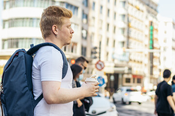 Young latino man who is albino walking down the city street