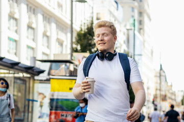 Young latino man who is albino walking down the city street