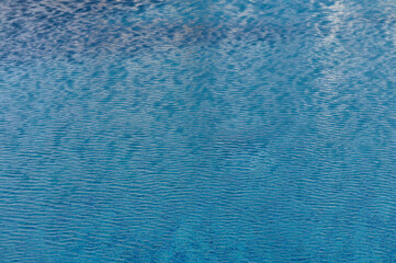 Ripple Water in swimming pool with sun reflection 4