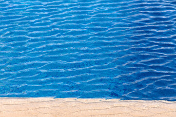 Ripple Water in swimming pool with sun reflection 1