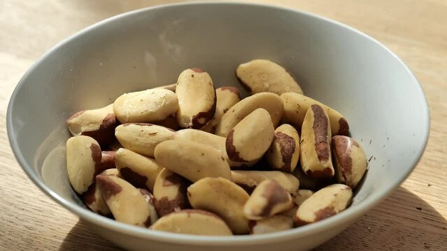 Brazil nuts cup on a wooden table .Healthy fats.Brazil nuts in the diet.Nuts and seeds. Keto diet ingredient. Useful healthy snack. 4k footage