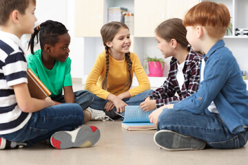 Cute children discussing in classroom at school