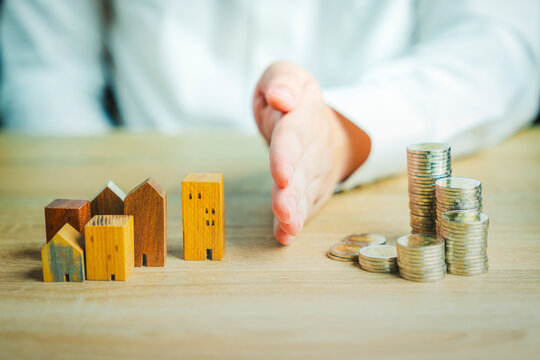 Wood house model and row of coin money on nature background, Real Estate market, Trading Estate, Mortgage Concepts