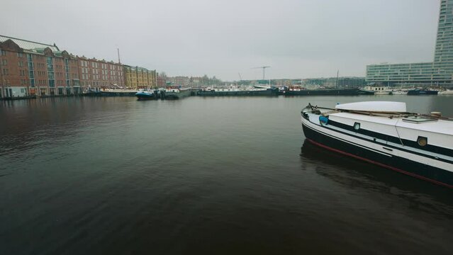 Amsterdam warehouses next to canal in Houthaven houseboat district during day