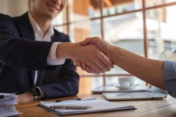 Businesspeople shaking hands in office.