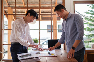 Creative designer or developer team using digital tablet working together on mobile app wireframe design at office.
