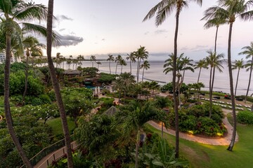 Fototapeta na wymiar Looking out upon the crystal blue Pacific Ocean and towering palm trees of Ka'anapali Beach, located in Lahaina, Hawaii on the island of Maui.