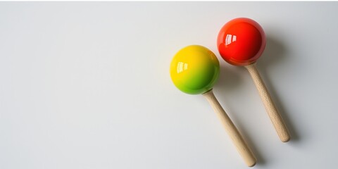 Pair of bright maracas on a white background, evoking musical rhythm and festive Latino culture.