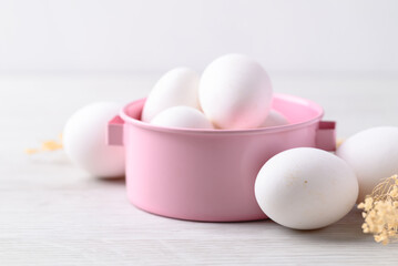Organic white leghorn egg from free range farm in pink bowl
