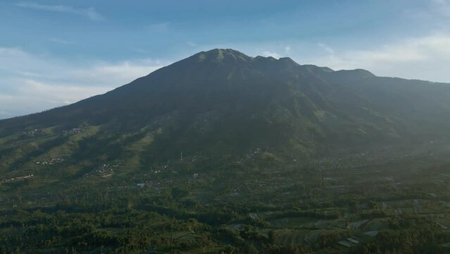 Aerial view of foggy morning in rural landscape of Indonesia with Merbabu Mountain. Beautiful natural landscape from drone camera. 4K drone shot.