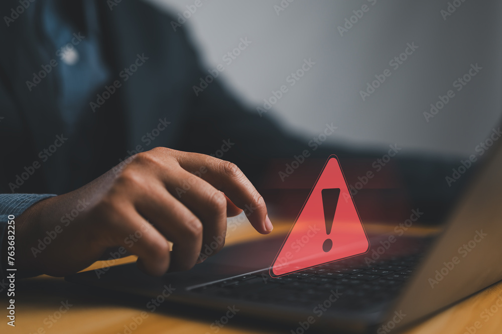 Poster Businessman or it staffs, programmer, developer using computer laptop with triangle caution warning sign for notification error and maintenance concept. Hack system alert, warning computer system
