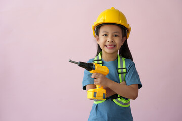 A little girl in a construction helmet and repair equipment Improving the premises About redevelopment, perspective ideas, planning, house design, architects, engineers, future careers.