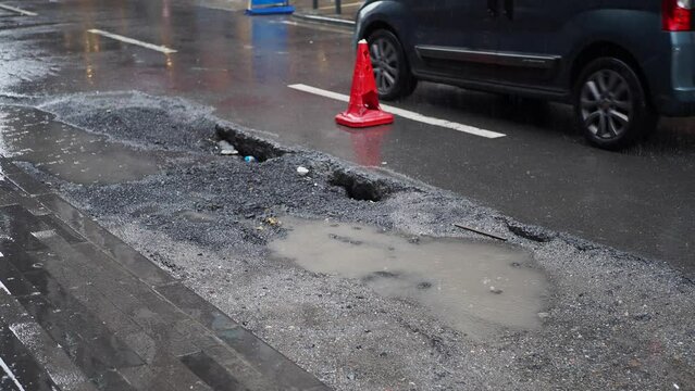 Big pot hole filled with water at street
